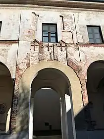 Remains of the Lombard bell tower incorporated in the Renaissance cloister.