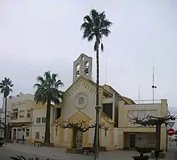 Sant Jaume d'Enveja church with its large bell-gable, Spain.