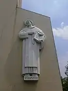 Bas-relief of Saint Dominic on the base of the belfry, sculpted by Francesco Riccardo Monti