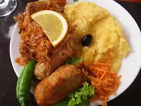 Image 4A popular Moldovan dish of sarmale (stuffed cabbage rolls), accompanied by sauerkraut and mămăligă (from Moldovan cuisine)