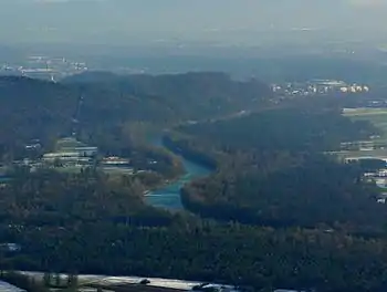 Aerial photo of a river winding through a wooded area