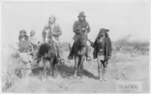 Image 7"Geronimo's camp before surrender to General Crook, March 27, 1886: Geronimo and Natches mounted; Geronimo's son (Perico) standing at his side holding baby." By C. S. Fly. (from Photojournalism)