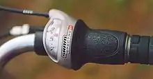 A modern SRAM Spectro S7 twist-style seven-speed indexed shifter uses the same bowden cable as the older lever.