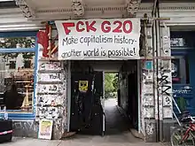 entrance with sign saying "Fuck G20"