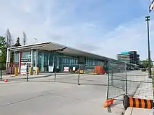 Photo of a glass panelled subway station and bus terminal behind protective fencing