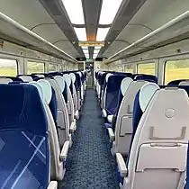 The interior of a refurbished ScotRail Mark 3 Standard Class with electronic destination displays.