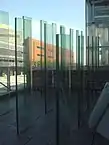 Three parallel rows of see-through glass plates