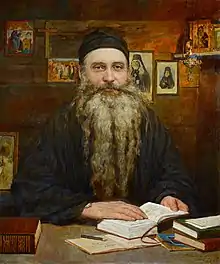 Painting of Seraphim Rose sitting at a desk in a cabin with an open book