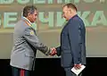 Defence Minister Sergey Shoigu congratulates a GRU employee