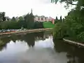 A view from the bridge looking downstream. The Abbey Gardens are on the right.