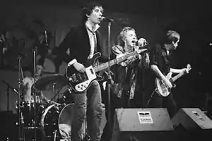 Members of rock band the Sex Pistols onstage in a concert.