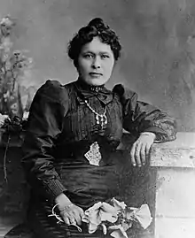 Kate Carmack, his wife, wearing her famous gold nugget necklace, 1898