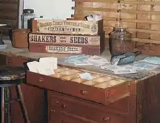 Shaker seed paper envelope packets being filled with various vegetable seeds