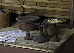 Weighing seeds before putting them into paper envelope packets