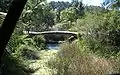 A photograph of the bridge to the primary school buildings across the creek.