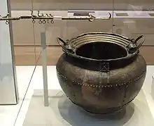 The right-hand side of the flesh-hook (the cauldron is unrelated)