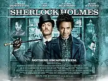 Robert Downey Jr. and Jude Law, in-character. The background is a window display, featuring shelves containing miscellaneous objects relating to the story. The poster reads "Sherlock Holmes" across the top, with the tagline "Holmes for the holiday" centered at the bottom. The poster is predominately turquoise coloured.