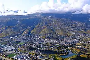 View of a city in front of a mountain.