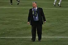 Schmid on the pitch in a suit