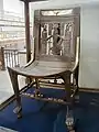 A cedar chair found in the Tomb of Tutankhamun, depicting Heh atop the hieroglyph for gold on the backrest