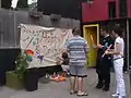 Families paint on the Pride banner, which became an annual tradition.