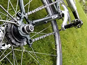 Bicycle chain tensioned without a dedicated tensioner mechanism