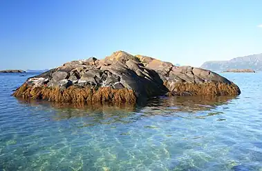 Skerry in shallow water, located just outside Krøttøy