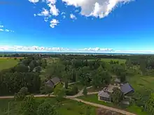 Houses with the Slīteres lighthouse in the background