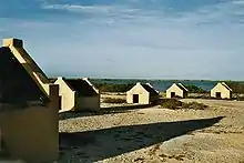 Image 6The forced African migrants brought to the Caribbean lived in inhumane conditions. Above are examples of slave huts in Dutch Bonaire. About 5 feet tall and 6 feet wide, between 2 and 3 slaves slept in these after working in nearby salt mines. (from History of the Caribbean)