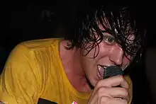 Quinn performing with Sleeping with Sirens in 2012