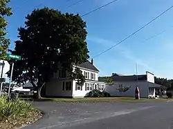 House and commercial building in Modest Town, July 2018