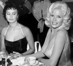 Sophia Loren and Jayne Mansfield, seated at a restaurant table