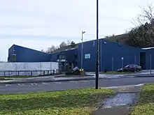 Blue building partially obscured by sheeting.