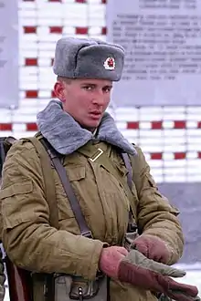 Russian soldier wearing the ushanka with the winter version of the afghanka; both the afghanka collar and the ushanka are made from "fish fur"