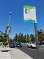 Bus stop sign at a stop featuring a bus bulb curb