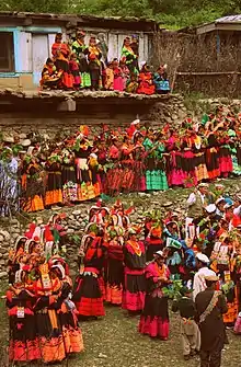 Celebrating Joshi, Kalash women and men dance and sing their way from the dancing ground to the village arena, the Charso, for the end of the day's festivities.