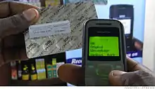 A drug package with Sproxil label and phone showing SMS reply.