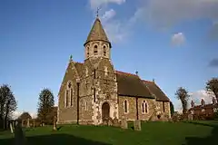 St John the Baptist's Church, High Toynton, Lincolnshire, 1872 by Ewan Christian, showing the unusual south-west porch tower with broaches to the octagonal upper storey and topped by a short spire