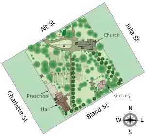 Vector graphics site map with streets, buildings, the cemetery, pathways, and trees marked.