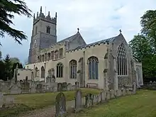 A stone church with a Gothic tower