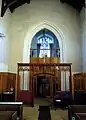 The former rood screen is at the church's west end