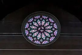 The large western Rose Window, with tracery designed by William Henry Skinner, glazed with cathedral glass, was the only stained glass installed during construction, 1895.