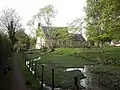 Disused watercress bed, dating from the 1950s, and parish church