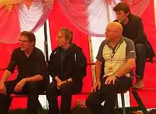 Stackridge being interviewed at the 2008 Glastonbury Festival. From the left: Andy Davis, James Warren, Mutter Slater and Crun Walter.