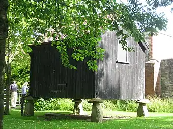 Building sitting on staddle stones, at the Somerset Rural Life Museum, similar to Iberian hórreos.