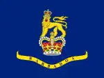 A blue flag with a crown and lion in the center, placed above a banner.