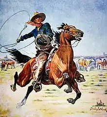 Au milieu d’une prairie, des vaches broutant en arrière plan, un cheval est lancé au grand galop. Son cavalier équipé d’un chapeau en cuir, d’un bandana rouge, d’une chemise bleue et de longue chaps en cuir, fait tourner son lasso.