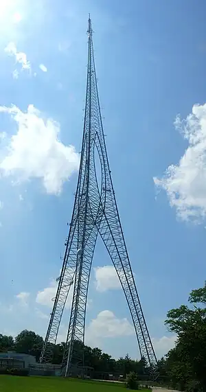 A dark-colored telecommunications tower with an unusual design