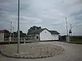 Old railway station building and parking entrance.