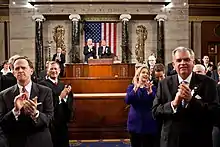 The rostrum of the House of Representatives, where the Speaker sits. The national motto is carved in marble over the seat of the presiding officer of the chamber